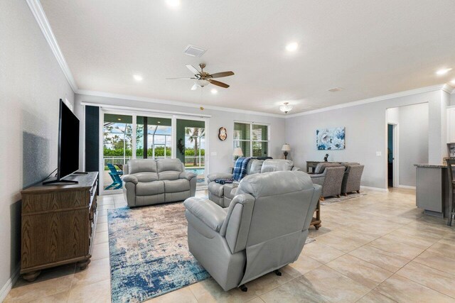 living area featuring arched walkways, light tile patterned floors, ceiling fan with notable chandelier, visible vents, and crown molding