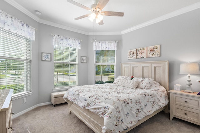 carpeted bedroom with ceiling fan and ornamental molding