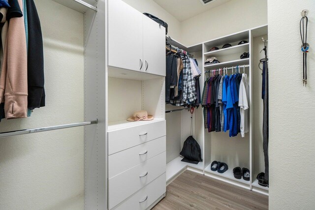 bedroom featuring ceiling fan, ornamental molding, wood finished floors, and baseboards