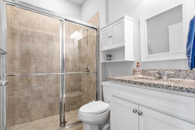 bathroom featuring vanity, toilet, and walk in shower