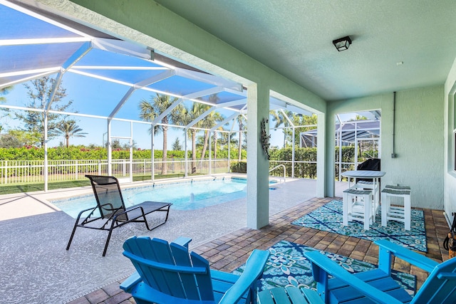 view of patio / terrace with a fenced in pool and glass enclosure