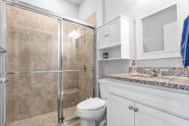 laundry area with light tile patterned floors, washing machine and dryer, a sink, baseboards, and cabinet space