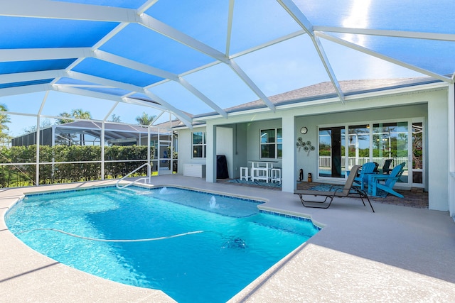 view of swimming pool featuring a lanai and a patio