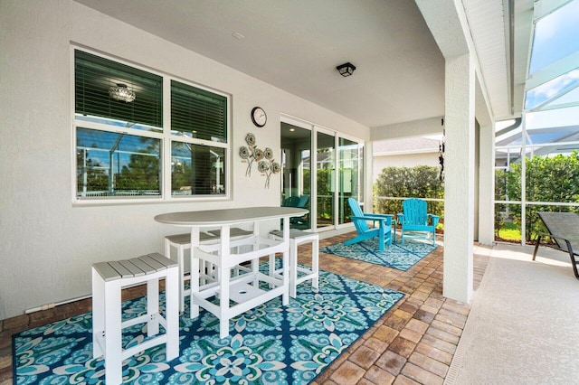 view of patio / terrace featuring glass enclosure