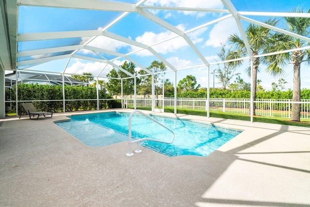 view of pool with a lanai, a patio area, fence, and a fenced in pool