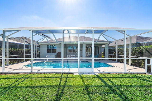 view of pool with a patio, ceiling fan, a lanai, and a lawn