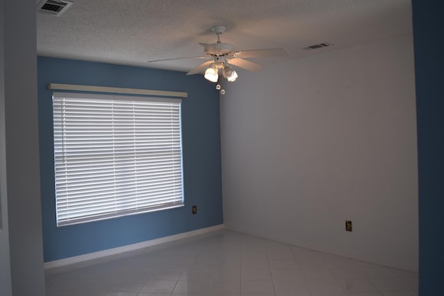 empty room featuring ceiling fan and a textured ceiling