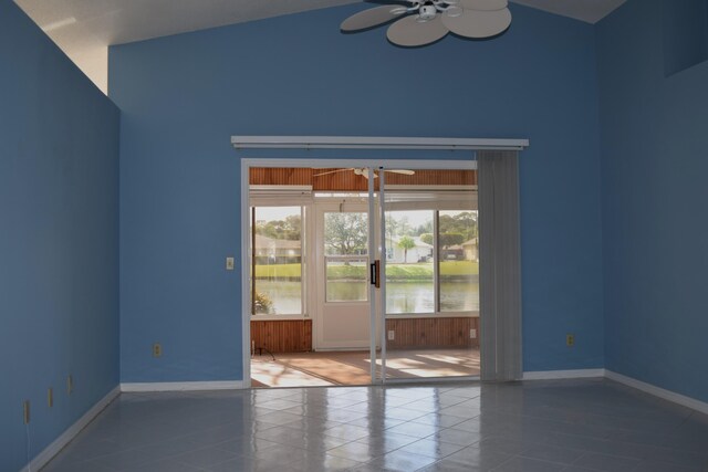 empty room featuring ceiling fan and tile patterned flooring