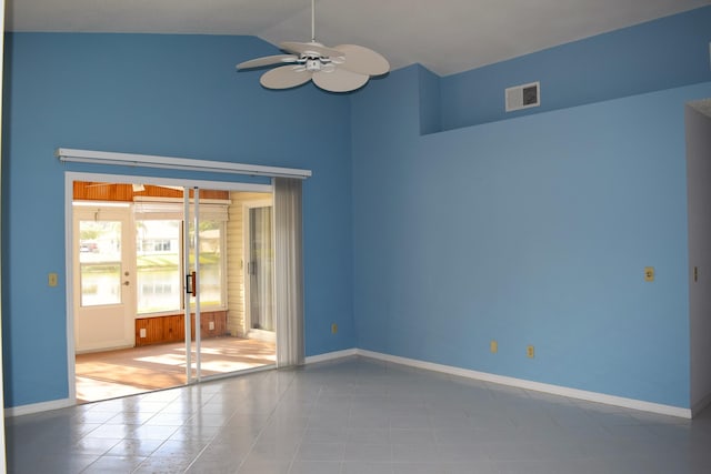 tiled spare room featuring french doors, vaulted ceiling, and ceiling fan