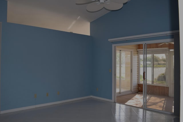 tiled spare room with ceiling fan and lofted ceiling