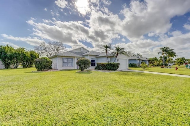 ranch-style home with a garage and a front yard