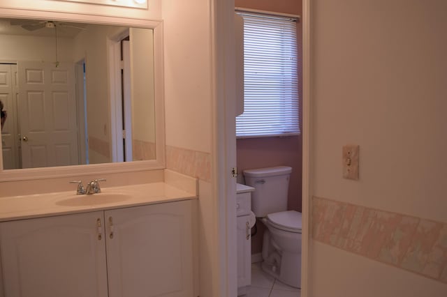 bathroom with tile patterned flooring, vanity, and toilet