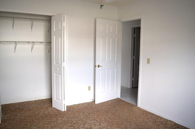 unfurnished bedroom with carpet floors and a closet