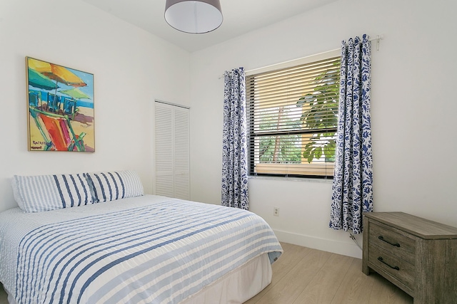 bedroom featuring light hardwood / wood-style flooring and a closet