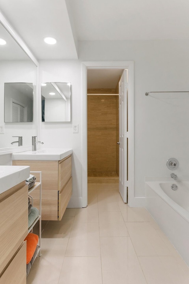 bathroom with tile patterned floors, vanity, and shower with separate bathtub