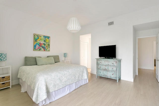 bedroom with a closet and light hardwood / wood-style flooring