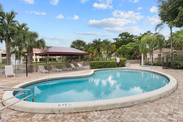 view of swimming pool with a gazebo and a patio area