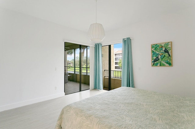 bedroom with light wood-type flooring and access to outside