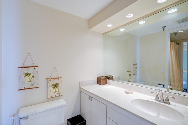 bathroom featuring vanity and toilet