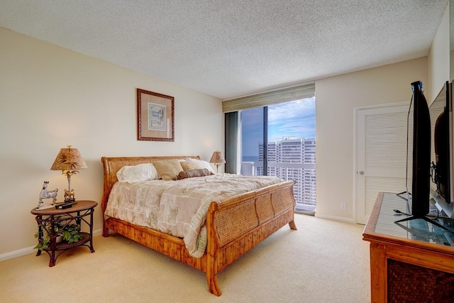 carpeted bedroom with a textured ceiling