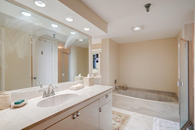 bathroom with tile patterned flooring, vanity, and separate shower and tub