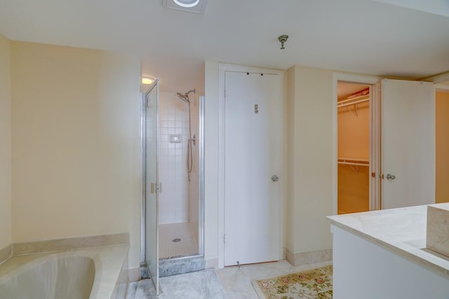 bathroom with tile patterned floors, vanity, and separate shower and tub