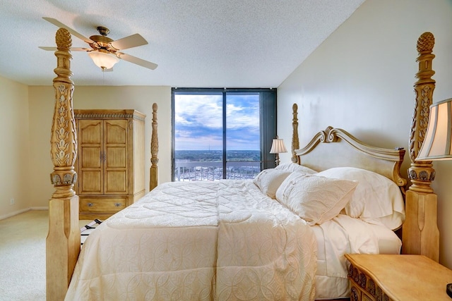 carpeted bedroom featuring ceiling fan, access to exterior, and a textured ceiling