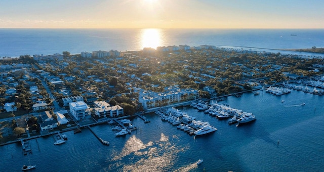 aerial view at dusk featuring a water view