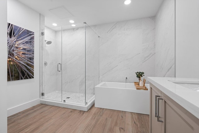 bathroom featuring vanity, hardwood / wood-style flooring, and separate shower and tub