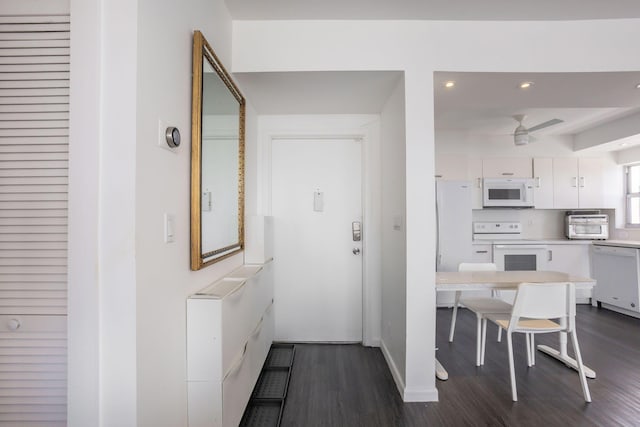 kitchen with ceiling fan, white cabinetry, white appliances, and dark wood-type flooring