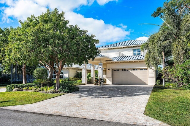 view of front of property featuring a garage and a front lawn