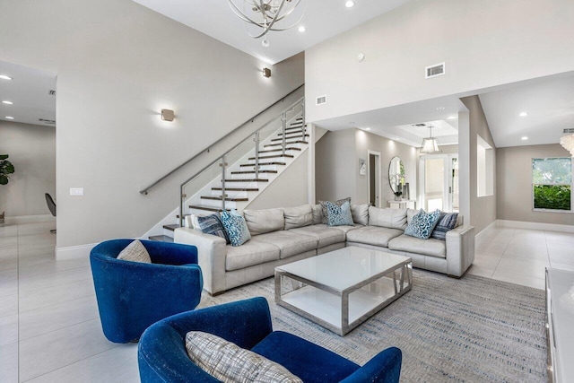 tiled living room with a towering ceiling and an inviting chandelier