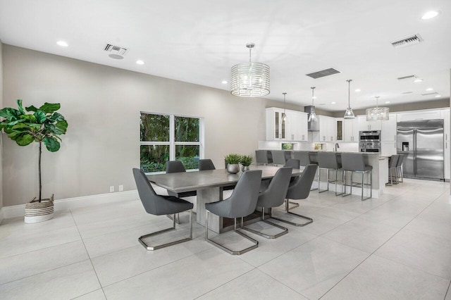 dining room with light tile patterned floors and sink