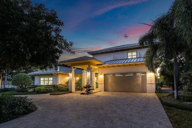 view of front of property with a balcony and a garage