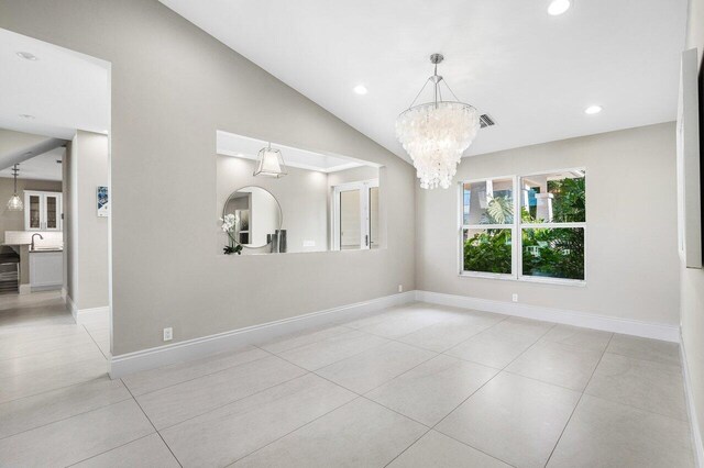 kitchen with sink, wall chimney exhaust hood, decorative backsplash, white cabinetry, and stainless steel appliances