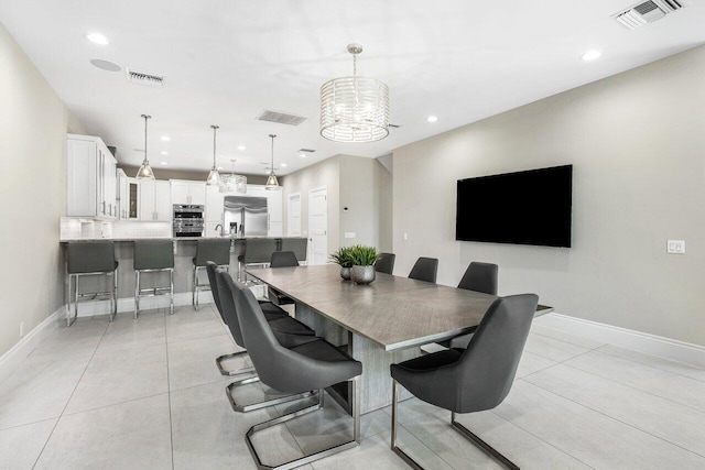 tiled dining area featuring a notable chandelier