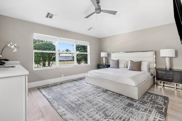 bedroom with light wood-type flooring and ceiling fan