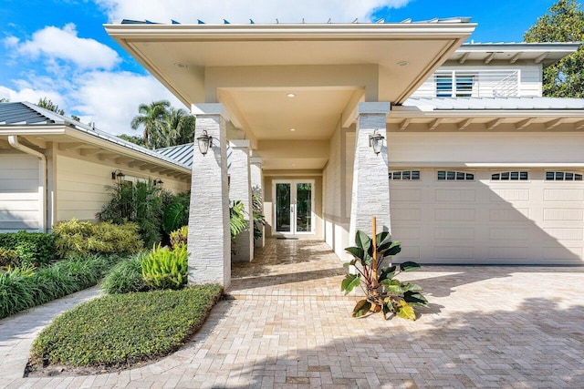 property entrance with a garage and french doors