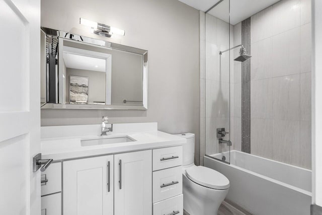 full bathroom with vanity, toilet, and tiled shower / bath combo