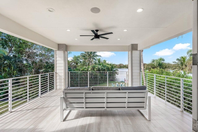 wooden deck featuring outdoor lounge area and ceiling fan