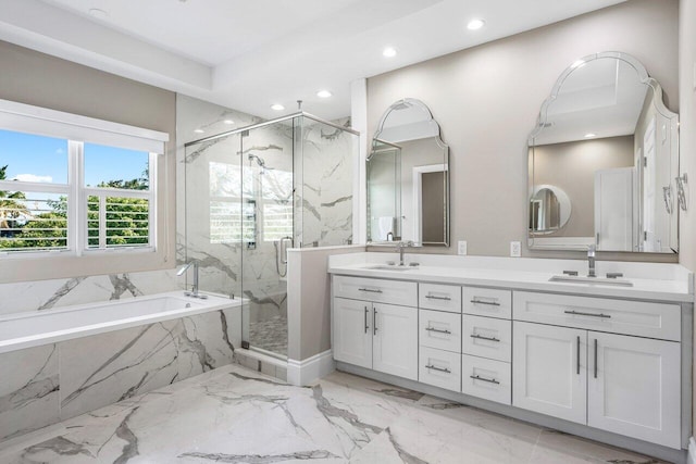 bathroom featuring vanity and independent shower and bath