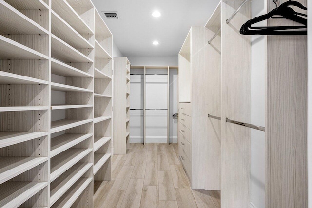 walk in closet featuring light hardwood / wood-style flooring