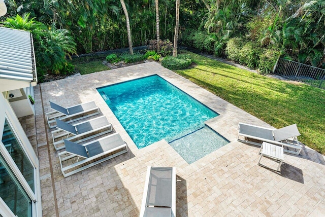 view of swimming pool featuring a lawn and a patio