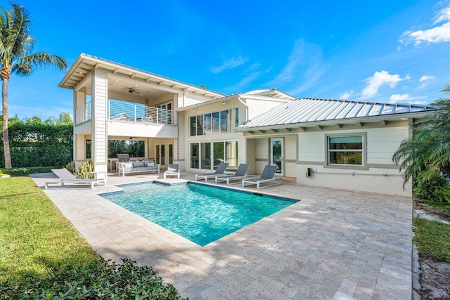 rear view of house featuring ceiling fan, a balcony, an outdoor hangout area, and a patio