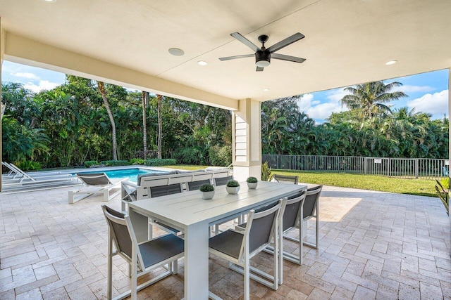 view of patio / terrace with ceiling fan and a fenced in pool