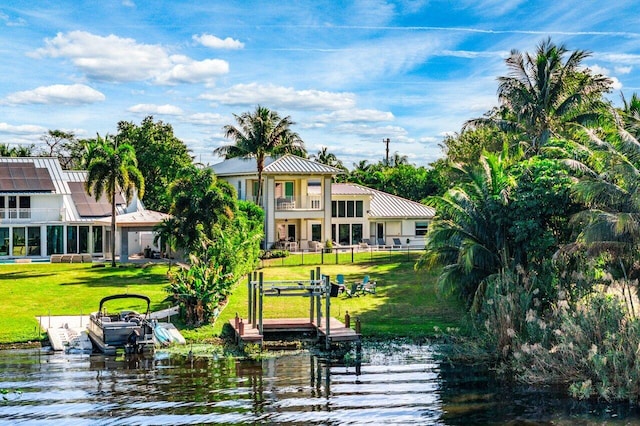 exterior space with a lawn, a water view, and a balcony