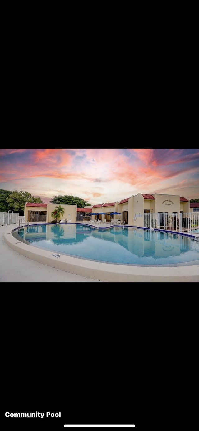 view of pool at dusk