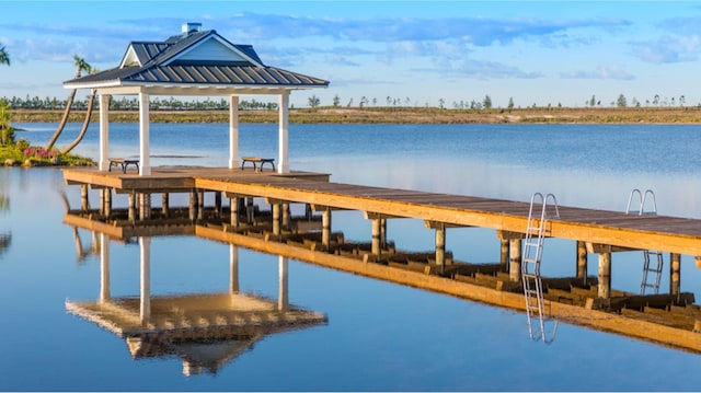 view of dock with a gazebo and a water view