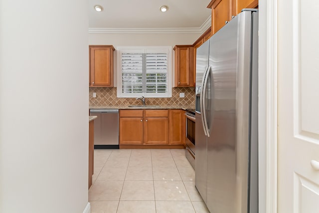 kitchen with decorative backsplash, light tile patterned floors, stainless steel appliances, and ornamental molding