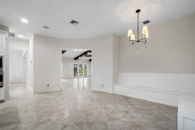 unfurnished dining area with an inviting chandelier and beam ceiling